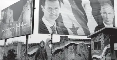  ?? HASSAN AMMAR / AP ?? Syrian children walk by posters of Syrian President Bashar Assad and Russian President Vladimir Putin on Jan. 18 in Aleppo.