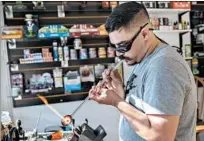  ?? ERIN HOOLEY/CHICAGO TRIBUNE ?? Pete Rivers creates a blown-glass pipe on Dec. 5 at his shop Zen Den Glass and Vape in River Grove.