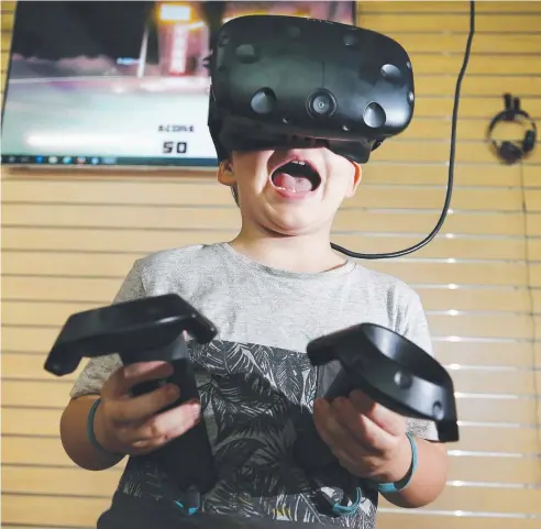  ?? Picture: BRENDAN RADKE ?? THIS IS WILD: Noah Newley, 4, of Holloways Beach, tries out the virtual reality system.