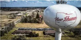  ?? JIM NOELKER / STAFF ?? A water tower stands on the west side of the village of New Lebanon, Ohio. The village council recently put five village leaders on leave.