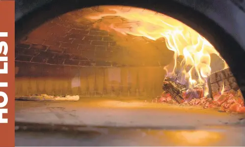  ?? L TODD SPENCER/STAFF FILE ?? A 12-inch Margherita pizza with San Marzano tomatoes, mozzarella, fior di latte, Romano, basil, garlic and extra-virgin olive oil being cooked inside a wood-fired oven at Andiamo Pizza Napoletana, located off South Battlefiel­d Boulevard in Chesapeake.