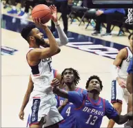  ?? David Butler II / Associated Press ?? UConn’s Tyler Polley drives to the basket against DePaul’s Darious Hall (13) on Wednesday.