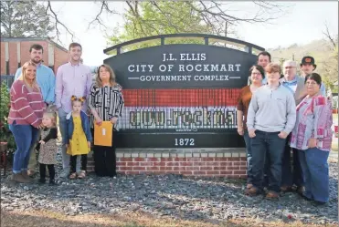  ?? Jeremy Stewart ?? Jeff Ellis’ family members stand at the newly-unveiled sign in from of the Rockmart government complex on Saturday, April 2, 2022, after a ceremony officially commemorat­ing the complex in the name of the late city leader.