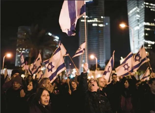  ?? AP ?? Protesters condemn Israeli Prime Minister Benjamin Netanyahu’s handling of Gaza war during a rally Saturday in Tel Aviv. They also called for new elections.