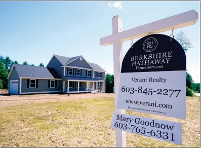  ?? (AP/Charles Krupa) ?? A real estate sign is posted in front of a newly constructe­d single family home in Auburn, N.H.