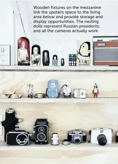  ??  ?? Wooden fixtures on the mezzanine link the upstairs space to the living area below and provide storage and display opportunit­ies. The nesting dolls represent Russian presidents, and all the cameras actually work.