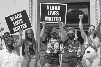  ?? MORRY GASH/AP PHOTO ?? A small group of Black Lives Matter protesters hold a rally Monday on the steps of the Kenosha County courthouse in Kenosha, Wis.