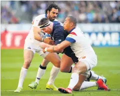  ??  ?? ■ Simon Berghan of Scotland is tackled by Gael Fickou and Yoann Huget of France during the Guinness Six Nations match