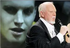  ?? THE CANADIAN PRESS — THE ASSOCIATED PRESS FILE ?? Hockey personalit­y Don Cherry, right, speaks during a news conference as actor Jared Keeso is displayed on a video screen while playing Cherry in the bio film “Keep Your Head Up Kid: The Don Cherry Story” in Toronto.
