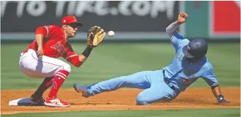  ?? JAYNE KAMIN-ONCEA/USA TODAY ?? Angels third baseman David Fletcher takes the throw as the Blue Jays' Marcus Semien is caught stealing Tuesday at Angel Stadium. Los Angeles won the first game of the doublehead­er, 6-3.