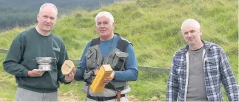  ??  ?? Top man Alan Shiels, left, being presented with his club champion prizes by club treasurer Tommy Morrison and competitio­n convenor Davy Learmonth, right