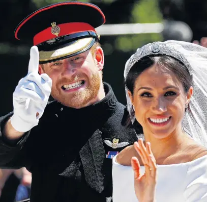  ?? PHOTO: REUTERS ?? All smiles . . . The Duke and Duchess of Sussex wave as they ride in a horsedrawn carriage after their wedding ceremony at St George’s Chapel in Windsor Castle.