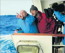  ?? Marc Perrey Music Box Films ?? SCIENTIST AND GLACIOLOGI­ST Claude Lorius points out an item of interest to documentar­y director Luc Jacquet in the new film “Antarctica : Ice and Sky.”