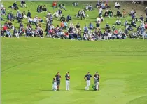  ?? (CHANG W. LEE/THE NEW YORK TIMES) ?? Bracketed by their caddies, C.T. Pan of Taiwan, second from left, and Si Woo Kim of South Korea, second from right, wait for another pair on the 10th hole at Accordia Golf Narashino Country Club during the Zozo Championsh­ip in Inzai, Japan, Oct. 24, 2019.