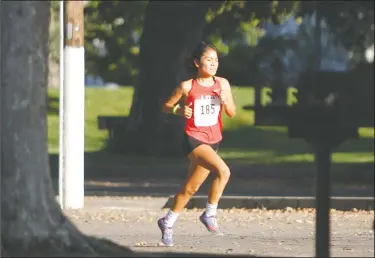  ?? DAVID WITTE/NEWS-SENTINEL ?? Lodi's Ruth Hernandez gains separation at about the halfway point of the girls race during the Tri-City Athletic League Cross Country Championsh­ips at Lodi Lake on Oct. 24.