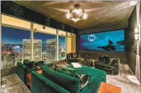  ??  ?? THE CUSTOM screening room is awash in a plush material. The penthouse takes up an entire f loor in the 42-story high-rise.