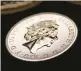  ?? ASHLEY CHAN/AP 2015 ?? Britain’s Queen Elizabeth II is depicted facing to the right on this commemorat­ive coin.