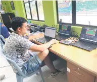  ?? ?? Osipov Slava mans the live streaming/live score during the fourth day of the World Junior Team Competitio­n (WJTC) Boys U14 AsiaOceani­a Final Qualifying at SLTA yesterday.