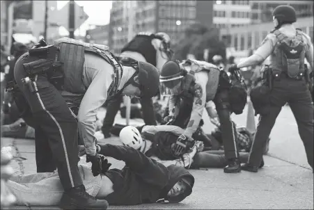  ?? XINHUA ?? Protestors are arrested in Minneapoli­s, Minnesota, the United States, on May 31. African American George Floyd died of suffocatio­n after being violently held down by the police in May, triggering a nationwide protest.