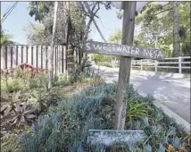  ?? Allen J. Schaben Los Angeles Times ?? A HAND-PAINTED rustic Sweetwater Mesa sign points to the Malibu hillside where The Edge and his investors plan to build.