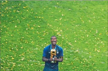  ?? REBECCA BLACKWELL/AP PHOTO ?? France’s Paul Pogba celebrates with the trophy at the end of the World Cup final Sunday at Luzhniki Stadium in Moscow. France won the championsh­ip 4-2, its second World Cup title, the first coming in 1998. Croatia was playing in its first final.