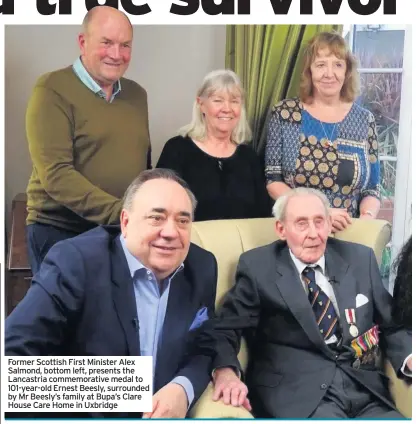  ??  ?? Former Scottish First Minister Alex Salmond, bottom left, presents the Lancastria commemorat­ive medal to 101-year-old Ernest Beesly, surrounded by Mr Beesly’s family at Bupa’s Clare House Care Home in Uxbridge