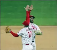  ?? LAURENCE KESTERSON — THE ASSOCIATED PRESS ?? Philadelph­ia Phillies right fielder Bryce Harper, right, and first baseman Rhys Hoskins, left, celebrate after their team defeated the New York Mets in a baseball game, Monday,