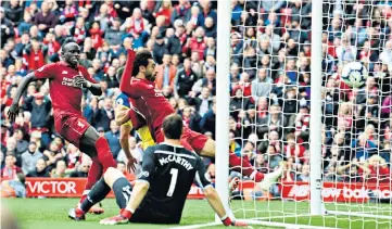  ??  ?? Finishing touch: Mohamed Salah taps in the rebound from Xherdan Shaqiri’s free-kick to end his run of three matches without a goal