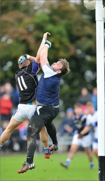  ??  ?? The crossbar comes to the Gaels rescue as Naomh Mairtin’s JP Rooney puts pressure on ‘keeper Stephen Faulkner. Pics: Ken Finegan