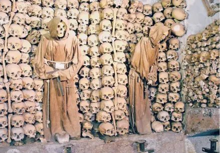  ?? RICK STEVES ?? In the Capuchin Crypt in Rome, the bones of 4,000 monks who died between 1528 and 1870 are lined up for wide-eyed visitors.