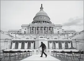  ?? PATRICK SEMANSKY/AP ?? A worker pulls cables Saturday as preparatio­ns take place for President-elect Joe Biden’s inaugurati­on ceremony at the U.S. Capitol in Washington on Wednesday