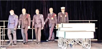  ??  ?? Halifax Regional Police and Fire Honour Guard walk away after delivering the caskets of the Barho family children during the funeral service. — Reuters photo