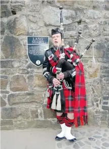  ?? PHOTOS: STEVE MACNAULL/POSTMEDIA NEWS ?? Roddy the Piper led us into Edinburgh Castle for a private dinner in the Queen Anne Room.