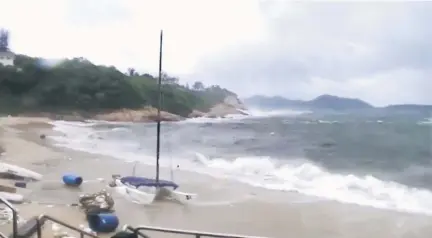  ??  ?? Still image taken from Reuters TV footage shows debris as waves crash on Shek O Beach, during Typhoon Hato in Hong Kong. — Reuters photo