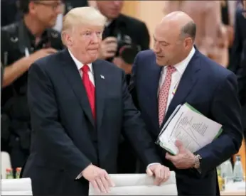  ?? AP PHOTO/MICHAEL SOHN, FILE ?? In this Saturday, July 8, 2017, file photo, White House chief economic adviser Gary Cohn, right, talks to U.S. President Donald Trump prior to a working session at the G-20 summit in Hamburg, Germany. Trump and his Republican partners in a nearly $6...