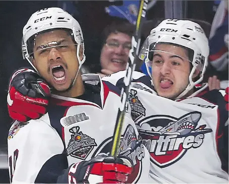  ?? DAN JANISSE ?? Jeremiah Addison, left, and Jeremy Bracco of the Spitfires celebrate Addison’s first of three goals against the Erie Otters Wednesday during round-robin action at the Mastercard Memorial Cup. By virtue of their 4-2 victory, the Spitfires earned a berth...