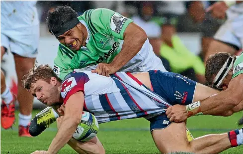  ?? PHOTO: GETTY IMAGES ?? Highlander­s co-captain Shane Christie – who is helping tackle Rebels wing Dom Shipperley – typifies the defensive mindset of the reigning Super Rugby champions.