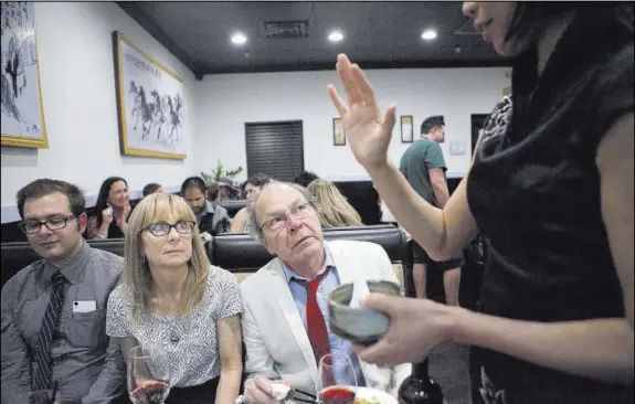  ?? PHOTOS BY LOREN TOWNSLEY/LAS VEGAS REVIEW-JOURNAL FOLLOW @LORENTOWNS­LEY ?? Leo Nima, from left, Sarah Zinman and James Norwood Pratt listen to fourth-generation tea artisan Kuei Fang talk about the preparatio­n and creation of teas at the tea tasting event at Niu-Gu restaurant. Participan­ts learned how to pair teas with their...