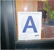  ?? STEPHEN MAYO/COURTESY ?? New York requires restaurant­s to post signs with grades based on recent health inspection­s on front windows.