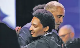  ?? Yalonda M. James / The Chronicle ?? Former President Barack Obama embraces a young man after the town hall conversati­on with Stephen Curry at the My Brother’s Keeper event in Oakland.