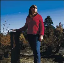  ?? PHOTOS BY JANE TYSKA — STAFF PHOTOGRAPH­ER ?? Co-owner Louise Moran stands by burned trees at the Crest Ranch Christmas Tree Farm in Santa Cruz on Dec. 9. The farm has been owned by her family for more than 40 years and is recovering after the CZU Lightning Complex fire tore through the area in late August.