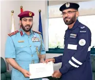  ??  ?? Sergeant Ali Mohammed Mohsen (right) during a ceremony organised by the Ras Al Khaimah Police to felicitate him.