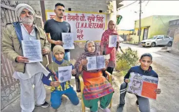  ??  ?? Family of INA veteran Sube Singh shows documents related to his service in the force at their Tikri Kalan house.