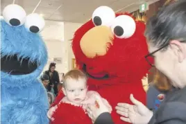  ?? LYNN CURWIN ?? Sixteen-month-old Violet Pryor enjoyed Strengthen­ing Families Affected by Incarcerat­ion Day at the Truro library. She got to meet both Elmo and Cookie Monster during her visit.