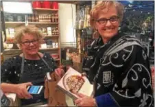  ?? PEG DEGRASSA — DIGITAL FIRST MEDIA ?? Sales associate Susan Schu rings up customer Jody Lausch of Litiz, Pa., during the Martha Stewart booksignin­g event Friday. Lausch said that her son Jordan, who works for Urban Outfitters, bought her the $35 ticket to the event for her birthday.