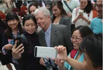  ?? SCOTT OLSON/GETTY IMAGES ?? University of Chicago professor Richard Thaler poses for selfies with fans at the university after it was announced he had been awarded the Nobel Prize in economics for his research in the field of behavioura­l economics.