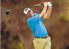  ?? JAMM AQUINO AP ?? Jim Herman follows through on his shot from the first tee on Thursday at the Sony Open. Herman finished the first round with a 6-under 64, two shots off the lead.