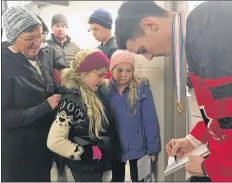  ?? FILE ?? Drake Batherson signs autographs for young fans in Berwick after winning gold as part of Team Canada at the IIHF World Juniors earlier this year.