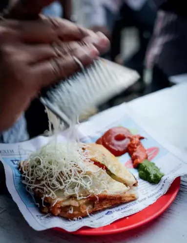  ??  ?? ABOVE The Bombay Sandwich – the city’s homegrown solution for hungry commuters: a vegetarian jaffle that’s toasted to order over hot coals.