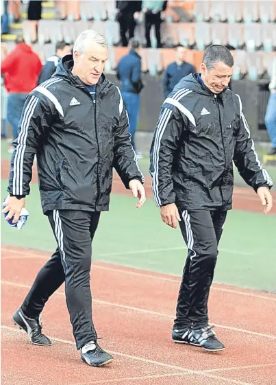  ??  ?? SINKING FEELING: John Sheran, left, and assistant Graeme Mathieson trudge off the park at Meadowbank after Cove were eliminated by Edinburgh City in the 2016 pyramid play-offs